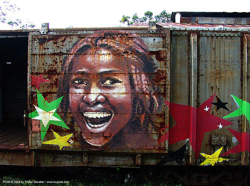 rasta-girl painting on train car - puerto limon (costa rica), abandoned - 19075334-rasta-girl-painting-train-car-puerto-limon-costa-rica