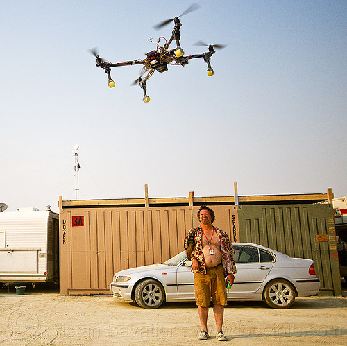 burning man - drone attacking unarmed insurgent, car, drone, flying, man, multicopter, quadcopter, quadrocopter, quadrotor helicopter, rc, remote controlled, shipping container, uav, unmaned aerial vehicle