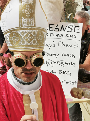 burning man - rory giving communion at center camp, attire, burning man outfit, communion, goggles, headdress, priest, waffle