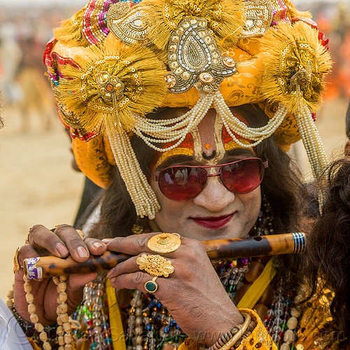 drag queen hindu guru playing flute - kumbh mela (india), beads, costume, decorated, dressed-up, finger rings, flute, guru, headdress, hindu pilgrimage, hinduism, kumbh mela, makeup, man, necklaces, sunglasses, tilak, tilaka, turban