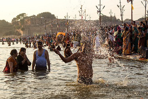 Hindu Devotees Having Holy Dip In Ganges River Splashing Water India