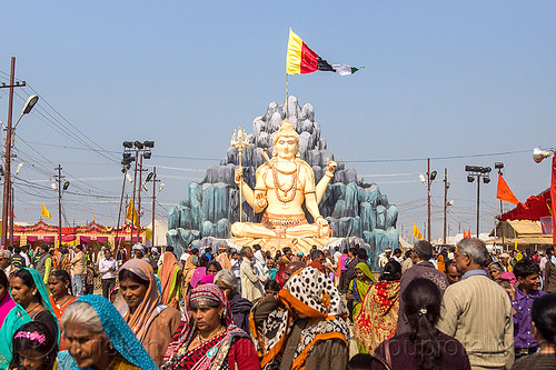 large statue of lord shiva at kumbh mela (india), ashram, crowd, flags, hindu ceremony, hindu pilgrimage, hinduism, kumbh mela, sculpture, shiva, statue, walking