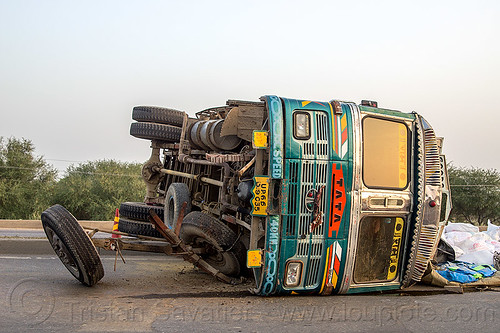 overturned truck on highway median (india), cargo, crash, freight, load, lorry accident, overturned, rice bags, road, rollover, spilled, tata motors, traffic accident, truck accident, wreck