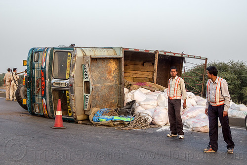 overturned truck - spilled load of rice bags (india), cargo, crash, freight, load, lorry accident, men, overturned, rice bags, road, rollover, sacks, spilled, tata motors, traffic accident, truck accident, wreck