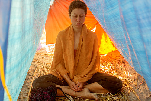 woman in yoga meditation, amal, cross-legged, eyes closed, hindu pilgrimage, hinduism, kumbh mela, meditating, meditation, rainbow camp, sitting, tarps, tent, woman, yoga