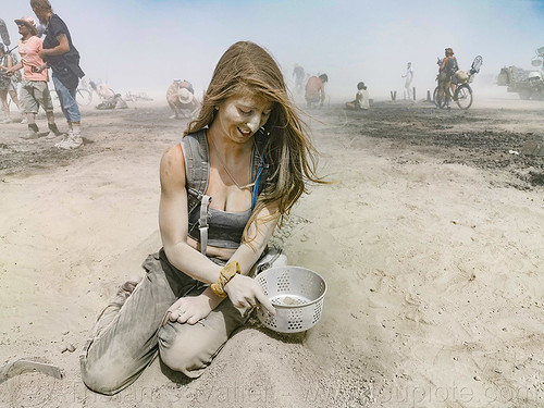 woman looking for quartz in man's ashes - burning man, ashes, dust, dusty, sifting, the man, woman