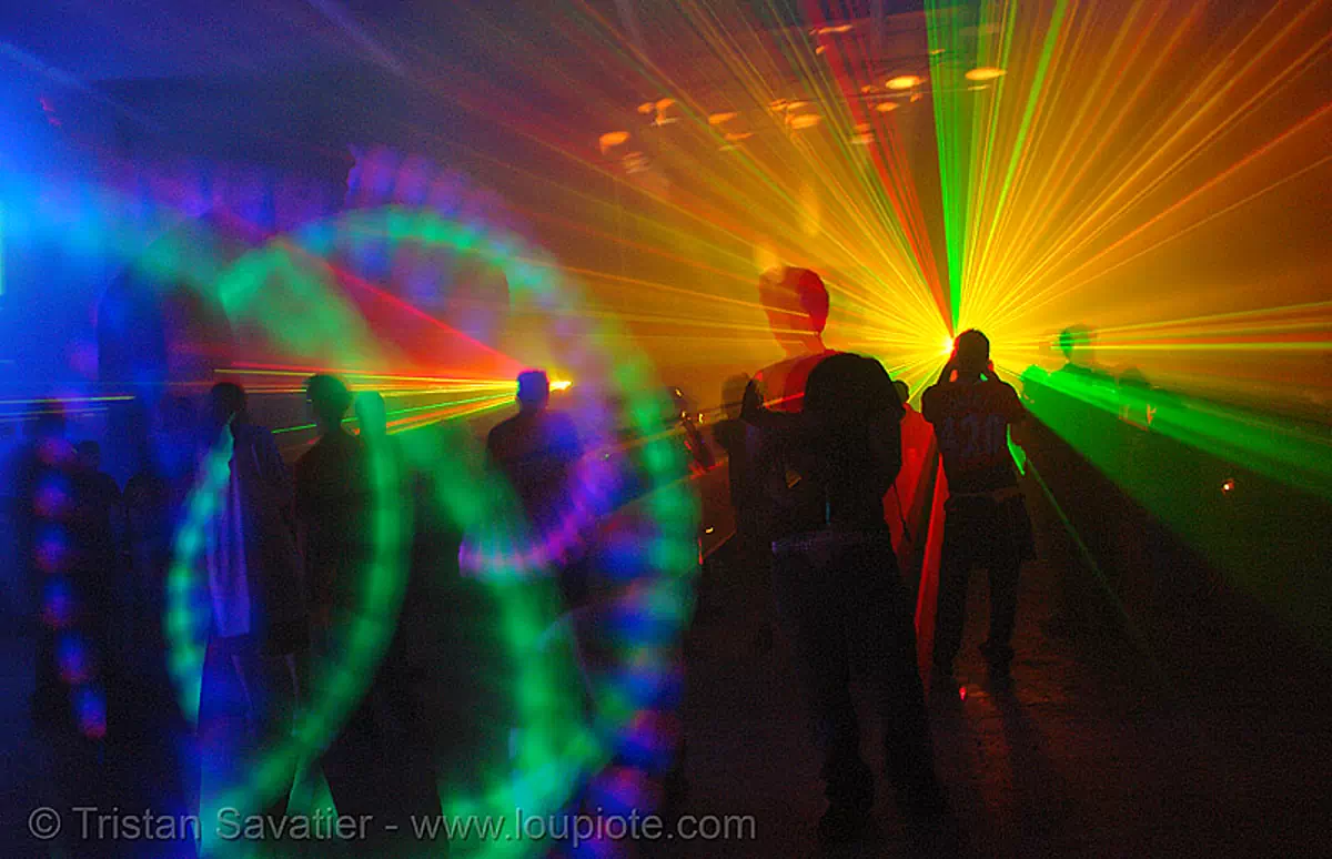 laser show, lights and shadows in warehouse underground rave party