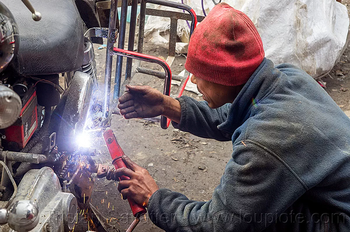 arc welding repair on motorbike rack, india