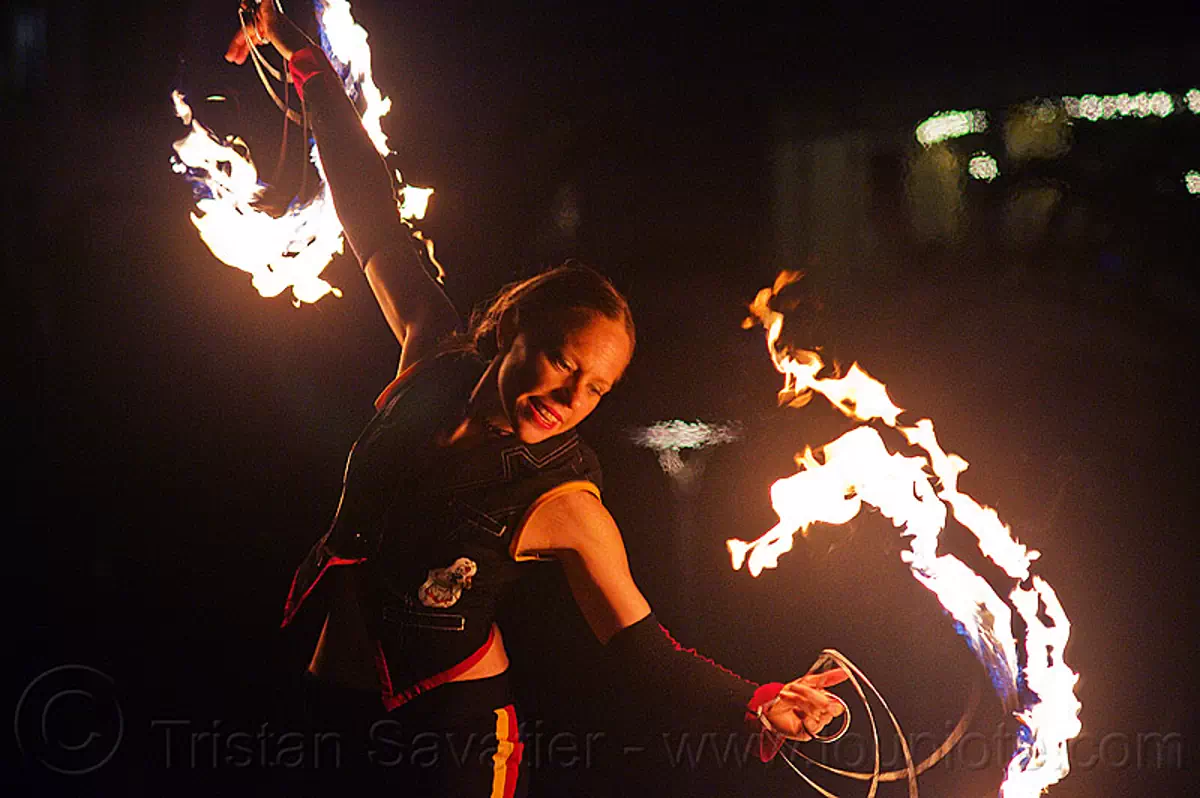 fire performer with fire fans, fire dancing expo, san francisco