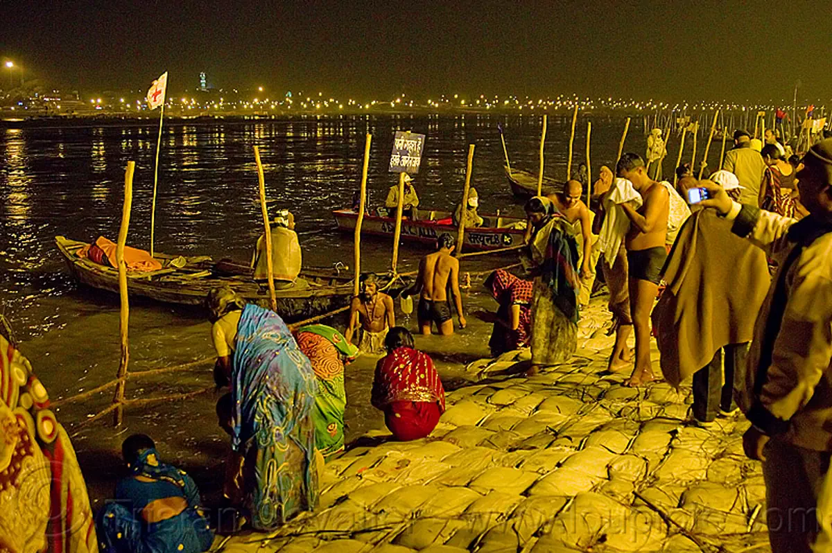 Hindu Pilgrims Bathing In The Ganges River At The Sangam At Night