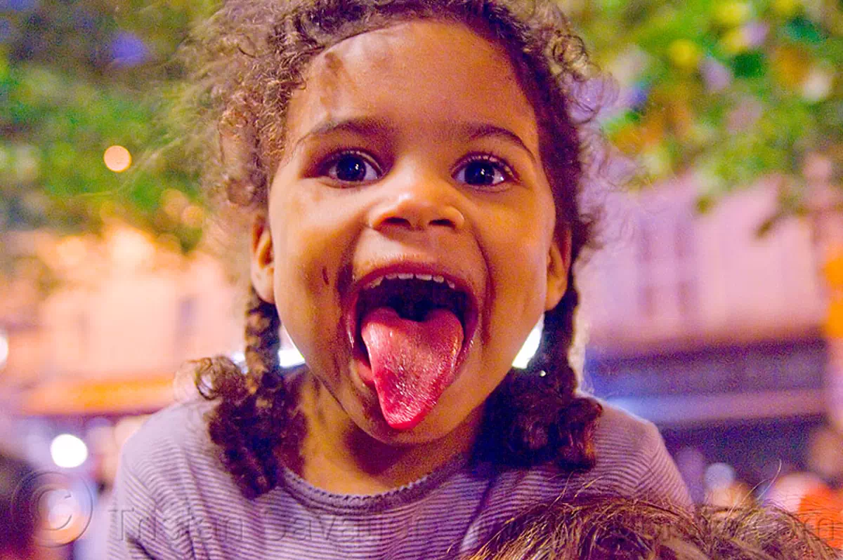 little girl sticking tongue out