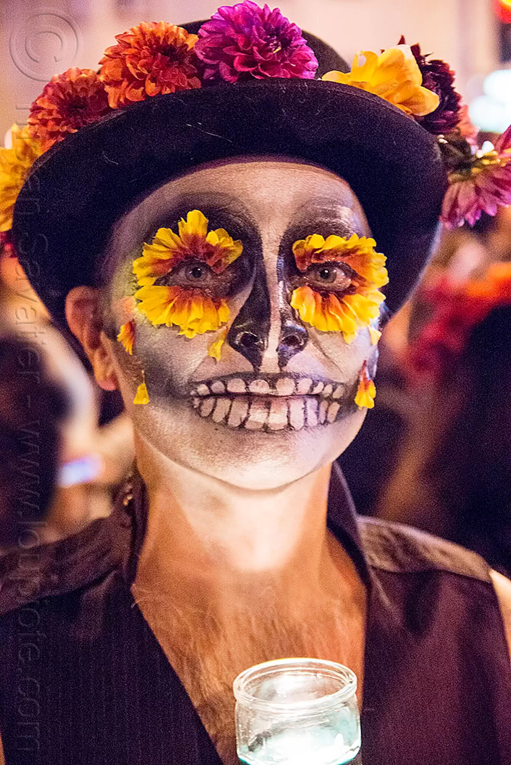 man with marigold flowers eyes and sugar skull makeup, dia ...