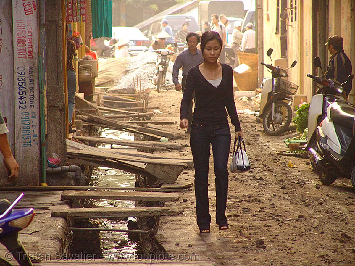 muddy street, open sewage (hanoi), vietnam