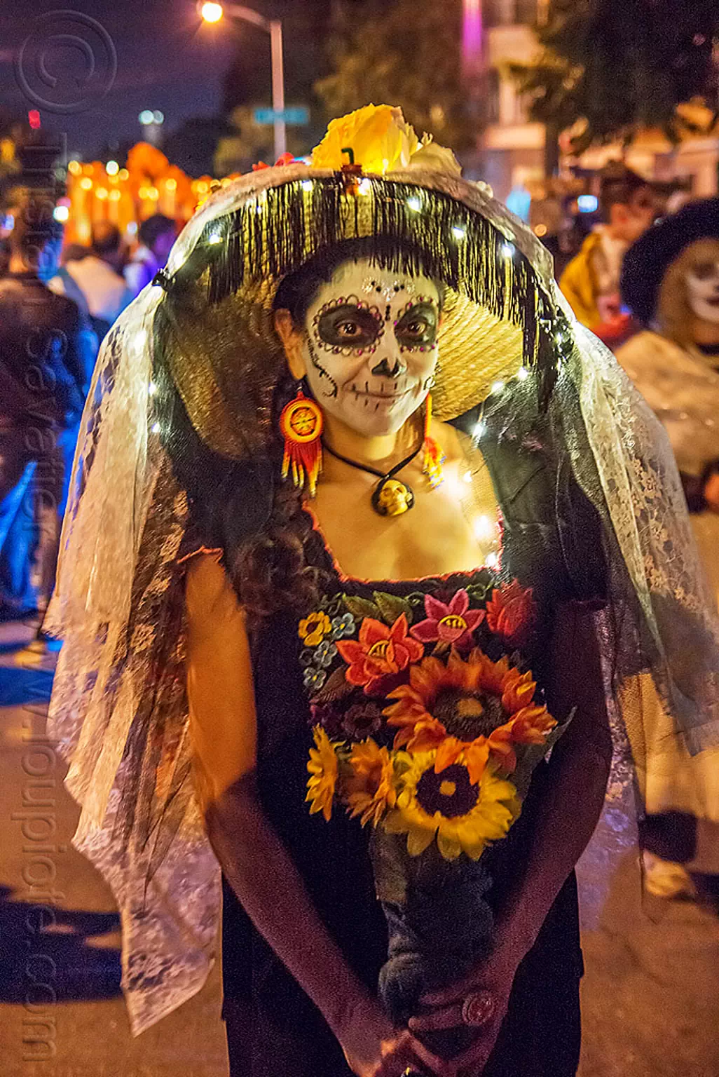 woman holding flower bouquet, dia de los muertos