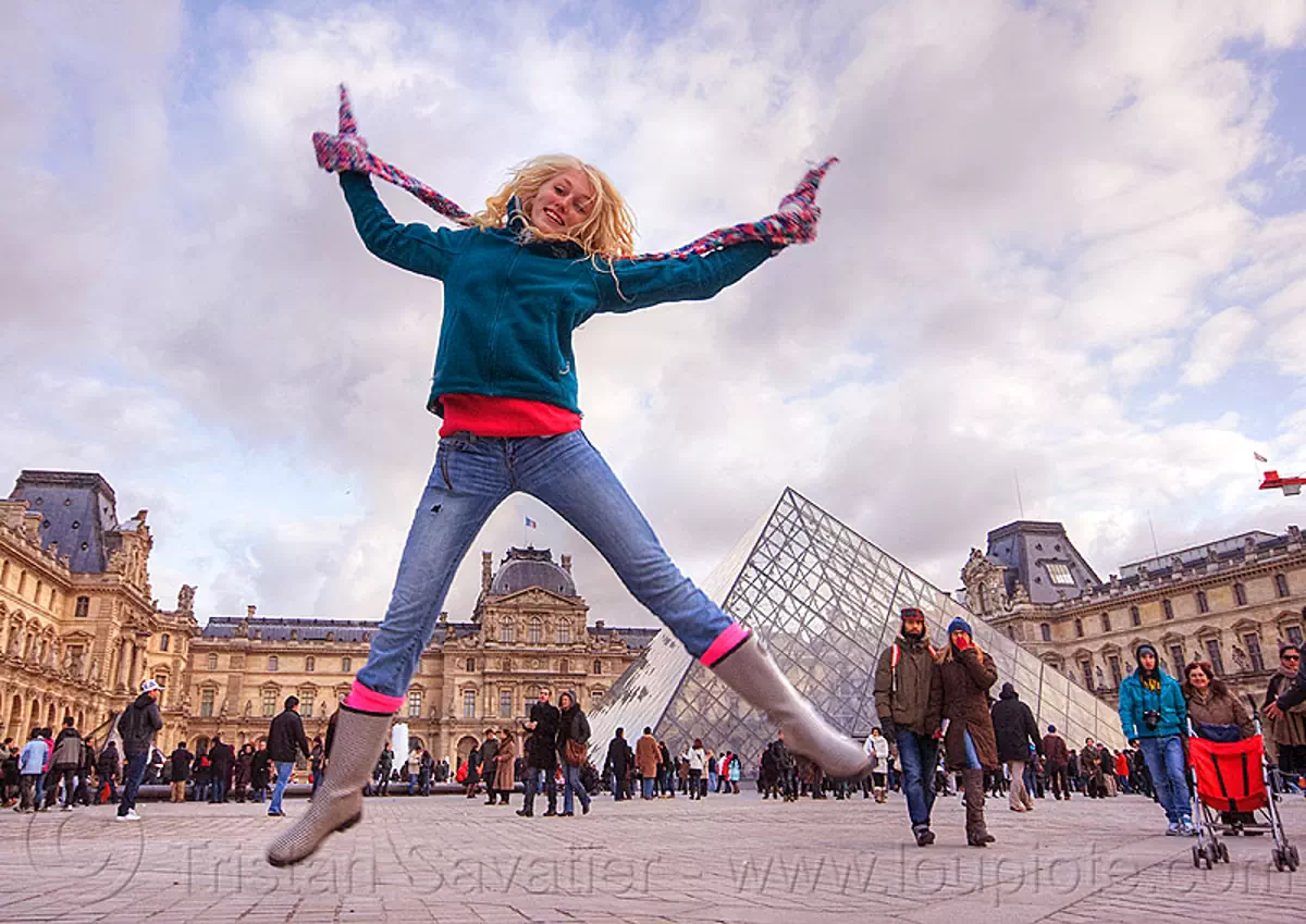 Girl Jumping at Le Louvre Pyramid