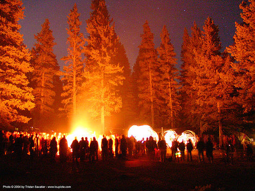 fire dancer using lightsticks rainbow gathering hippie 