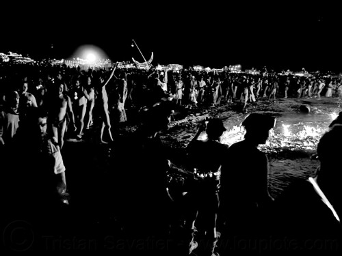 burning man - crowd dancing around the embers of the burnt man, burning man at night, crowd, night of the burn