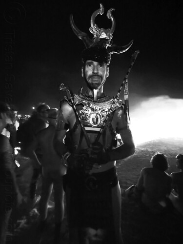 burning man - man in elaborate costume near the man burning, attire, beard, burning man at night, burning man outfit, headdress, headwear, night of the burn, vulturemaui