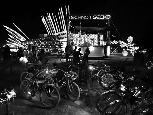 burning man - techno gecko art car, bicycles, burning man art cars, burning man at night, glowing, mutant vehicles, techno gecko art car