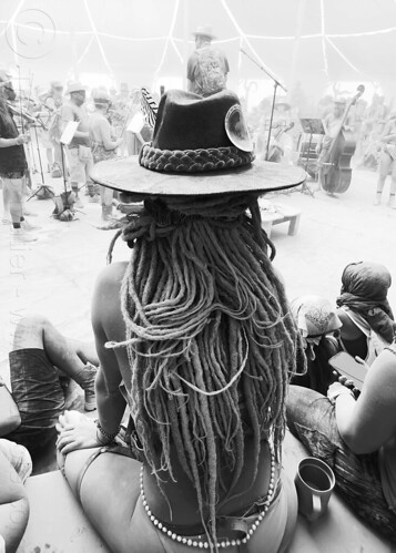 burning man - woman with long dreadlocks at center camp cafe, dreadlocks, dusty, hat, sitting, woman