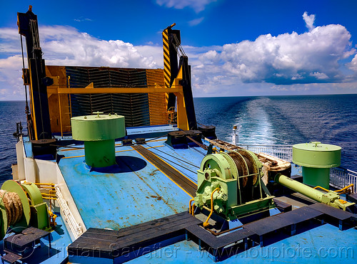 closed ferry ramp and ship wake view from the upper deck, cable winch, deck, exterior, ferry, ferryboat, horizon, ocean, outside, ramp, sea, ship wake