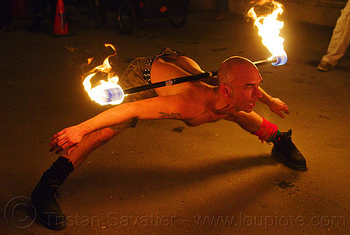 contact fire staff spinning by shanti, american steel studios, contact fire staff, contact staff, fire dancer, fire dancing, fire performer, fire spinning, fire staf, forward bend, holidays in flux, leg splits, leg spread, legs spread, man, night, poplar gallery, spinning fire