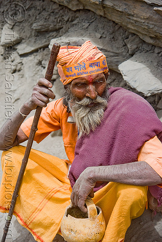 dusty old hindu pilgrim resting on trail - amarnath yatra (pilgrimage) - kashmir, amarnath yatra, baba, bhagwa, headwear, hiking cane, hindu holy man, hindu man, hindu pilgrimage, hinduism, kashmir, mountain trail, mountains, pilgrim, resting, sadhu, saffron color, walking stick