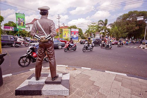 fake cop statue watching traffic - yogyakarta, cars, cop, fake, intersection, motorcycles, police officer, police uniform, policeman, sculpture, simpatik, statue, traffic, white cap