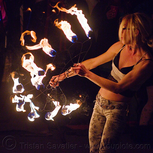 fire dancer with fire fans