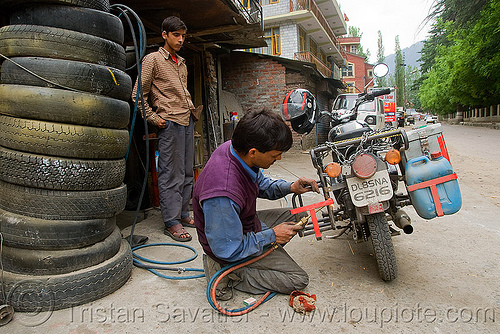 getting my cracked rack welded - manali (india), 500cc, bald tires, fixing, luggage rack, man, manali, mechanic, motorcycle touring, repairing, road, royal enfield bullet, tire stack, user tired, welder, welding torch, worker, working