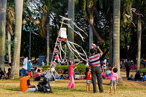 Kid flying a kite near the national monument (monas) in 