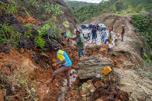 locals clearing landslide with hand shovels, bada valley road landslide, men, mountain road, road to bada valley, roadwork, working