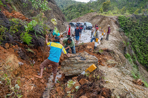 men clearing big landslide with hand shovels, bada valley road landslide, men, mountain road, road to bada valley, roadwork, working