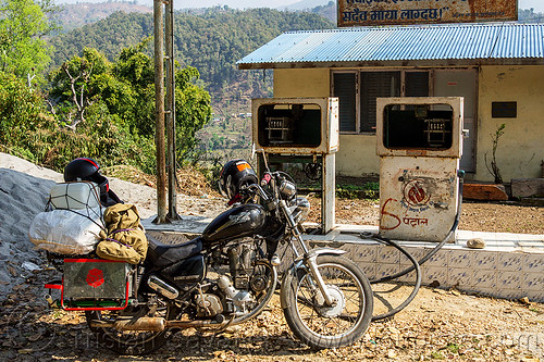 motorcycle at abandoned gas station (nepal), 350cc, bags, gas pump, gas station, luggage, motorcycle touring, petrol pump, petrol station, royal enfield bullet, thunderbird