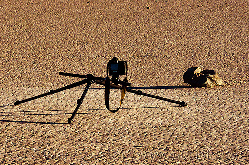 photographing a sailing stone on the racetrack - death valley, camera, death valley, dry lake, dry mud, racetrack playa, rock, sailing stones, sliding rocks, tripod