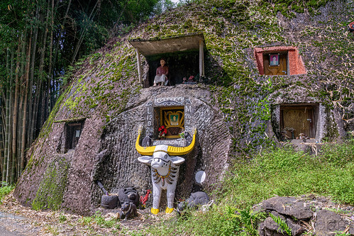 toraja rock-tombs with tau-tau effigy and carved water buffalo, burial site, cemetery, effigies, grave, graveyard, liang pak, pa'tedong, rock tombs, tana toraja, tau-tau, tomb