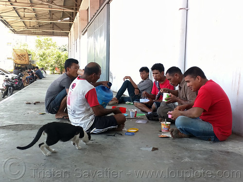 trucks drivers eating on dock, waiting to board the ferryboat, dock, eating, harbor, makassar, men, sitting