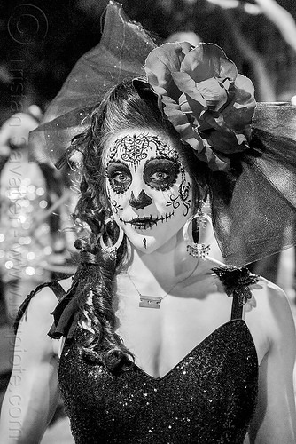 woman with intricate sugar skull makeup, black dress, headdress with ...