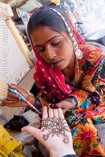 Female hands with henna tattoo praying. Beautiful indian mehendi ornaments  painted on a body part. Stock Photo | Adobe Stock